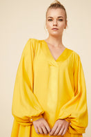 Bocan Couture Nora long buttoned saffron nightgown with flowing fabric and elegant design, displayed on a mannequin.