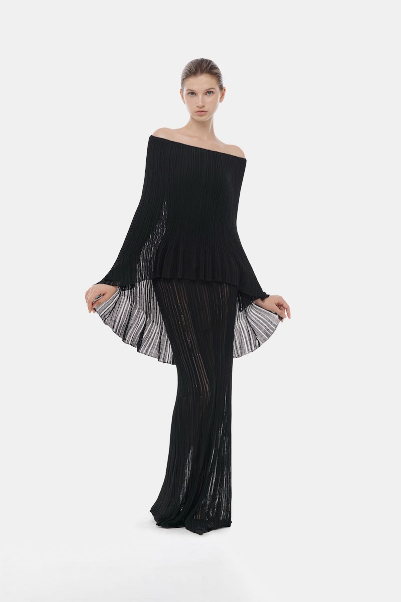 Black off-shoulder pleated maxi gown by Montsand, featuring flowing fabric and elegant design for formal occasions.
