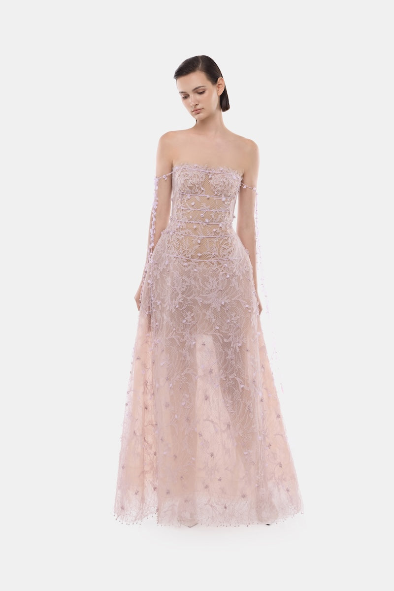 Montsand violet floral string maxi dress displayed on a model, featuring a flowing gown with adjustable straps and vibrant floral pattern.