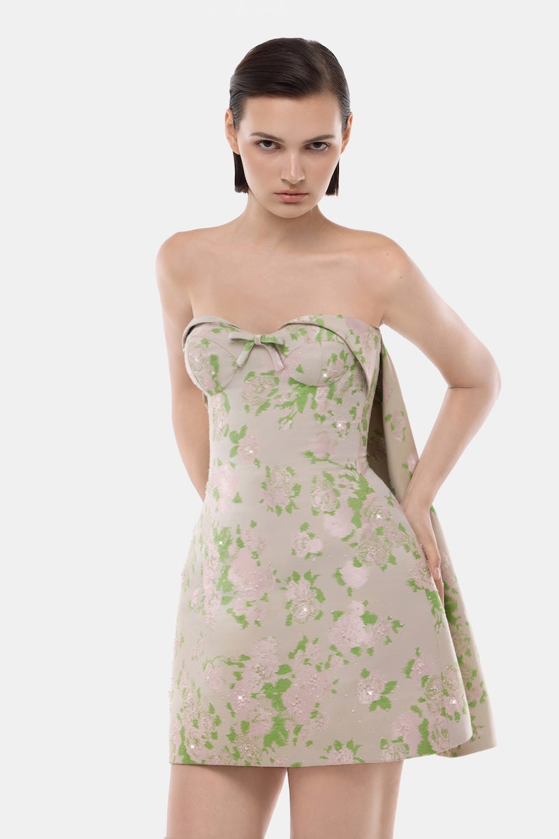 Montsand pastel corsetry mini dress with detachable cape, showcasing fitted bodice and flowing skirt in a stylish, elegant design.