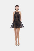 Black floral appliqué halter mini dress by Montsand, featuring a fitted silhouette and intricate floral detailing.