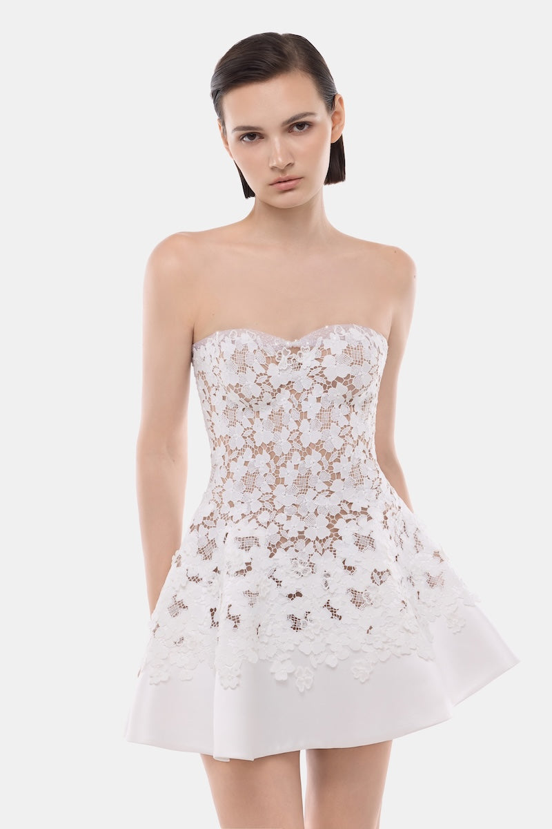 White detachable cape skater dress by Montsand, featuring a fitted bodice and flared mini skirt, perfect for stylish outings.