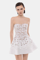 White detachable cape skater dress by Montsand, featuring a fitted bodice and flared mini skirt, perfect for stylish outings.