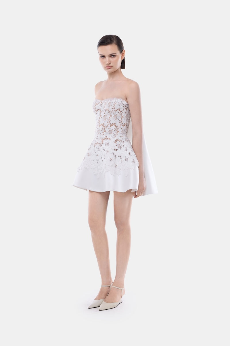 White detachable cape skater mini dress by Montsand, featuring a flowing silhouette and stylish design.