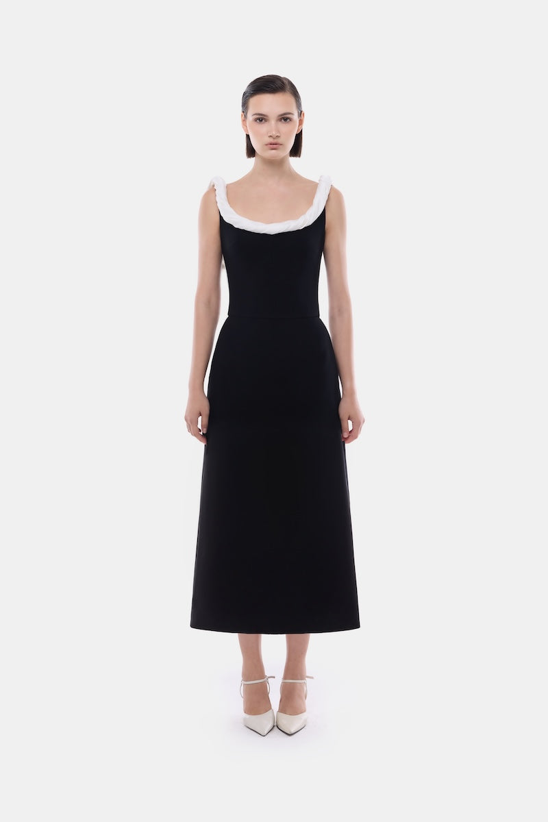 Black Montsand midi dress with a stylish low back and flowing fabric, perfect for elegant occasions.