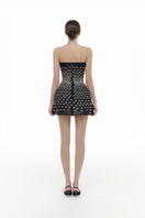 Black silver bow strapless mini dress by Montsand, featuring a fitted silhouette and stylish bow detail at the waist.