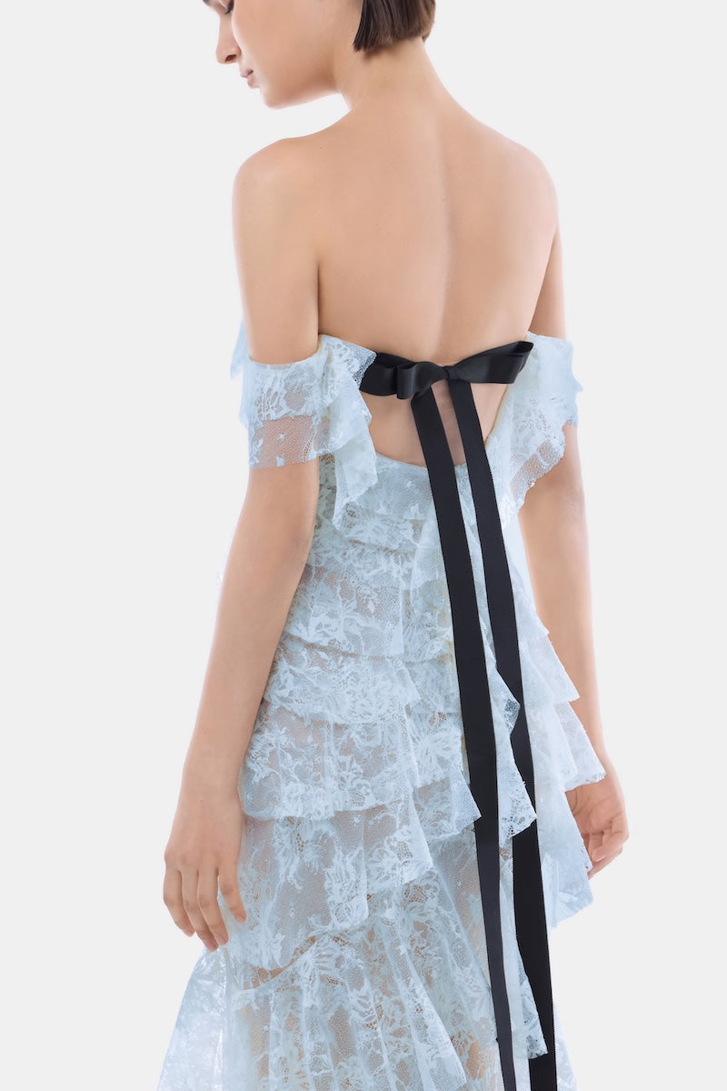 Blue lace ruffle strap-off gown by Montsand, featuring elegant lace details and flowing fabric, perfect for formal events.