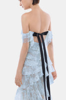 Blue lace ruffle strap-off gown by Montsand, featuring elegant lace details and flowing fabric, perfect for formal events.