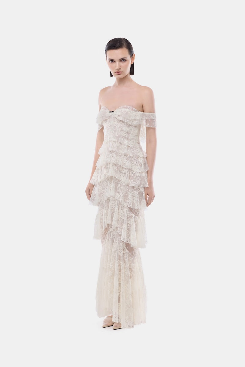 Ivory lace ruffle strap-off gown by Montsand, featuring delicate lace details and flowing fabric for elegant evening wear.
