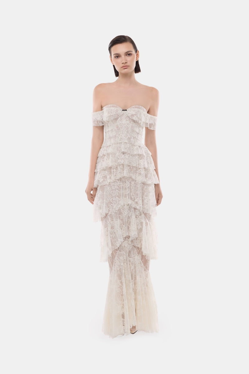 Elegant ivory lace ruffle strap-off gown by Montsand, featuring delicate lace details and flowing fabric for a sophisticated look.