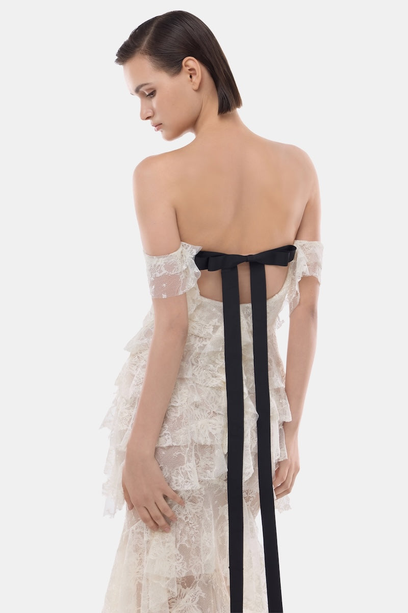 Ivory lace ruffle strap-off gown by Montsand with delicate lace details and flowing silhouette, perfect for elegant occasions.