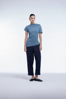 Asymmetrical short sleeve top by Dāl the Label, featuring a stylish cut and modern design, shown on a model.