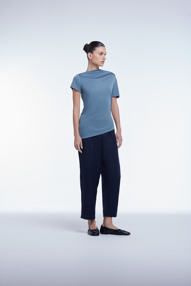 Asymmetrical short sleeve top by Dāl the Label, featuring a modern, stylish design with unique hemline and lightweight fabric.
