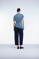 Asymmetrical short sleeve top by Dāl the Label, featuring a stylish, modern design with unique hem detail.