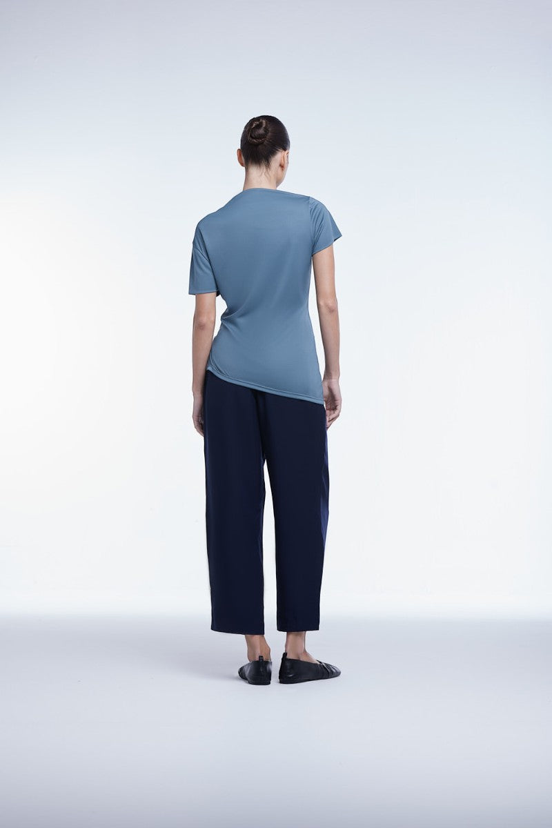 Asymmetrical short sleeve top by Dāl the Label, featuring a stylish, modern design with unique hem detail.