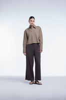 Cropped cotton button-down shirt by Dāl the Label, featuring a classic collar and relaxed fit, displayed on a hanger.