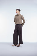 Dāl the Label cropped cotton button-down shirt displayed on a model, featuring a classic collar and long sleeves.