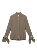 Olive green long cuff relaxed shirt by Dāl the Label, featuring a loose fit and casual style, shown flat on a white background.