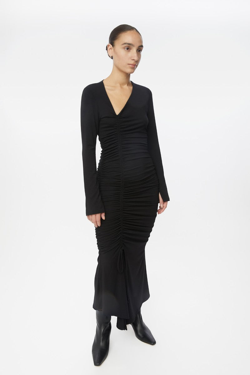 Dāl the Label modal ruched asymmetric midi dress in black, featuring gathered fabric and a stylish asymmetrical hem.