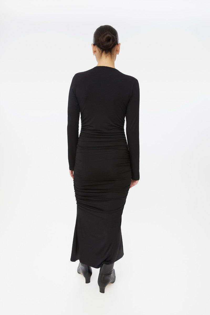 Dāl the Label modal ruched asymmetric midi dress displayed on a model, showcasing its elegant design and draped fabric.