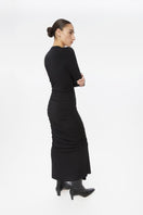Dāl the Label modal ruched asymmetric midi dress with draped fabric and elegant design, showcased on a model in the lookbook image.