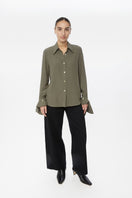 Relaxed long cuff top from Dāl the Label, featuring a comfortable fit and stylish design, shown in a fashion lookbook image.