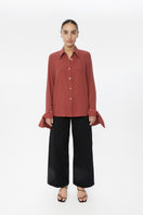 Relaxed long cuff top from Dāl the Label, stylish shirt with rolled cuffs and a comfortable fit, showcased in a fashion lookbook.