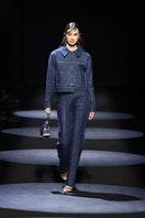 Blue denim jeans with chain accents on the legs, by JC Pajares, featuring a modern, edgy style perfect for casual wear.