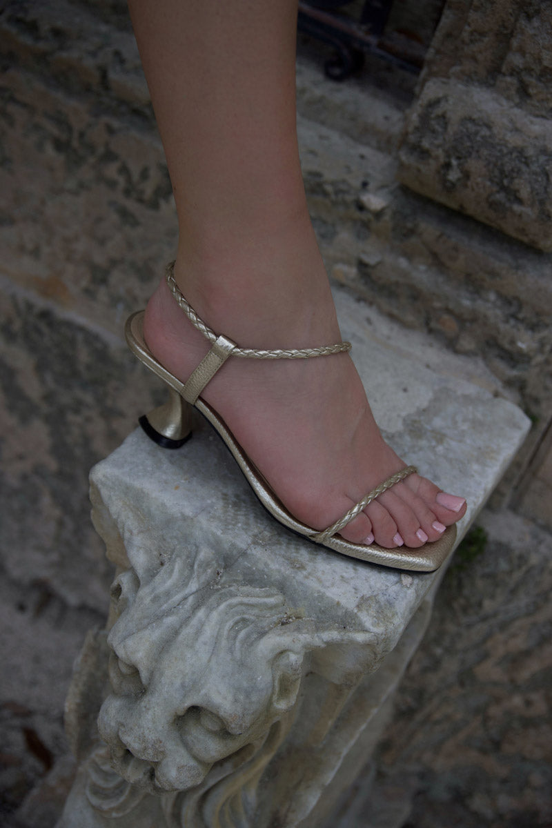 Alta Dora Gold Sandals featuring sleek design and metallic gold finish, perfect for casual summer wear.