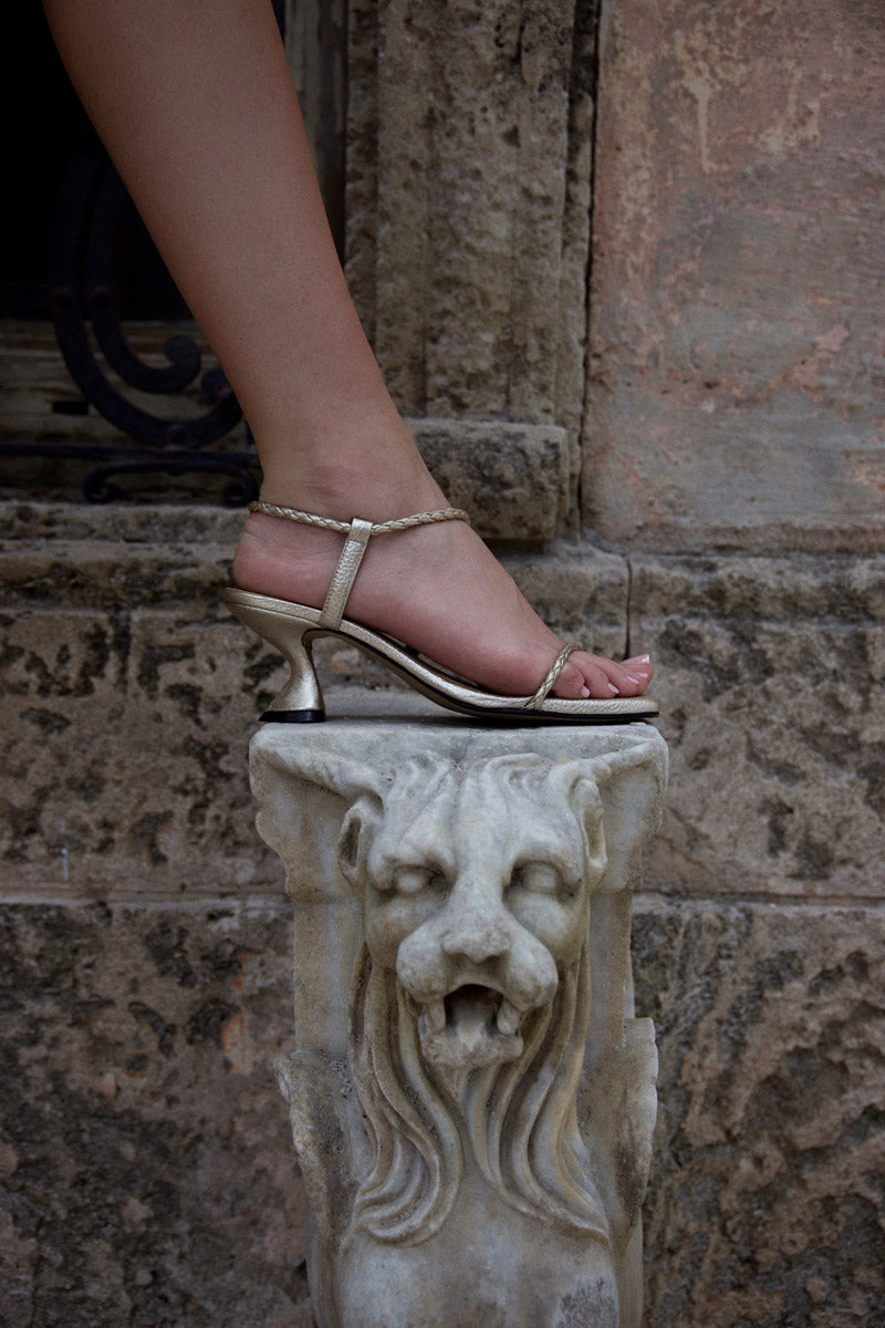 Alta Dora Gold Sandals featuring stylish gold straps and comfortable flat soles, perfect for casual summer outfits.