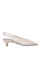 Ivory croc-embossed heels by 10th Floor featuring pointed toes and stiletto heels, styled with elegant design.