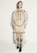 Elegant milky white maxi dress by NADYA DZYAK, flowing fabric with a stylish silhouette, showcased on a model.
