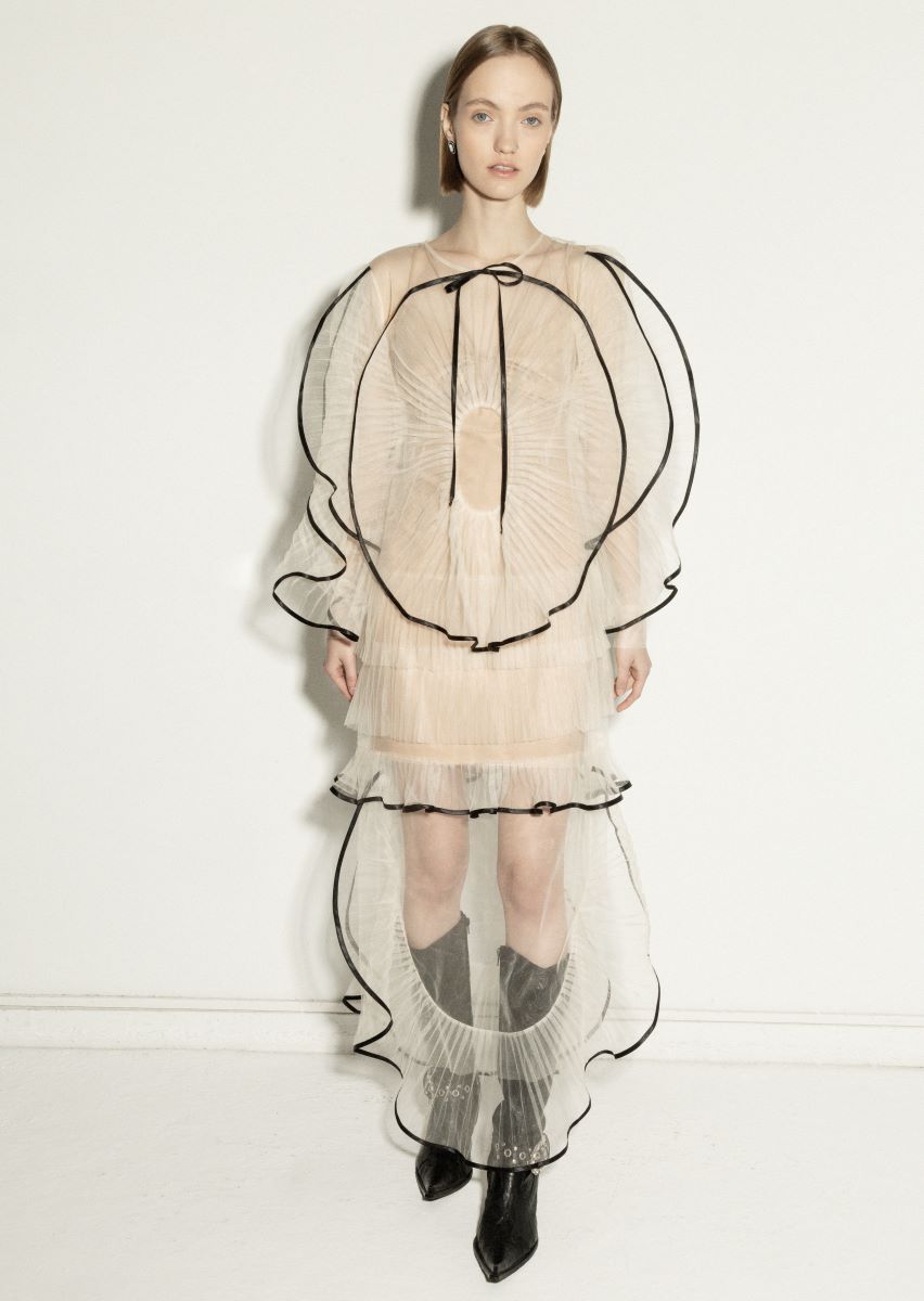 Elegant milky white maxi dress by NADYA DZYAK, flowing fabric with a stylish silhouette, showcased on a model.