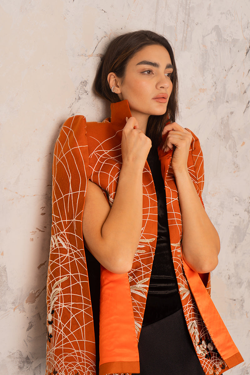 Nadya Shah Clementine cape jacket in soft fabric, draped over a mannequin, showcasing its stylish, flowy design and elegant color.