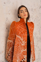 Nadya Shah Clementine Cape jacket in soft fabric, draped over a mannequin, showcasing its stylish design and elegant silhouette.