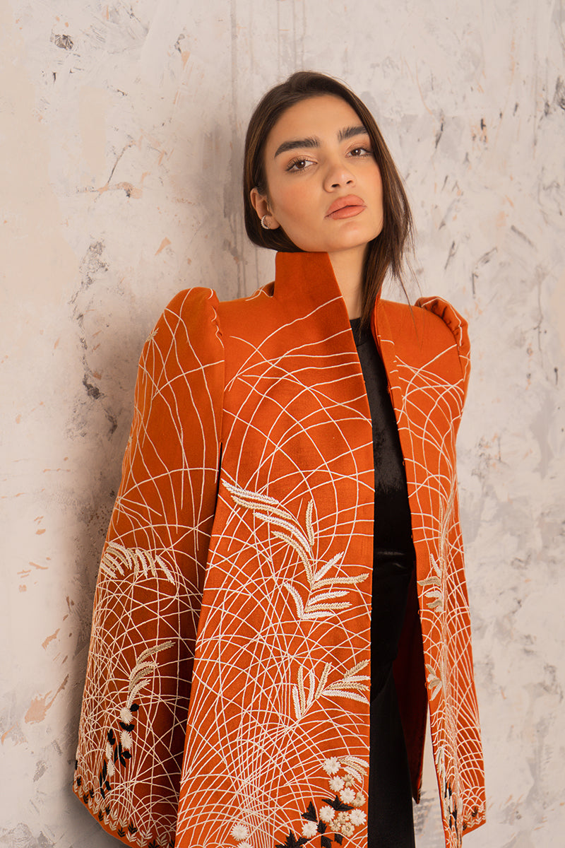 Nadya Shah Clementine Cape jacket in soft fabric, draped over a mannequin, showcasing its stylish design and elegant silhouette.