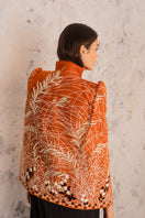Nadya Shah Clementine cape jacket in soft fabric with draped design, displayed on a hanger.