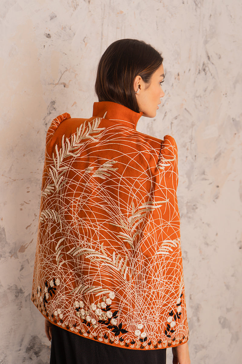 Nadya Shah Clementine cape jacket in soft fabric with draped design, displayed on a hanger.