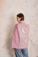 Nadya Shah Hydra Lilac Cape jacket displayed on a hanger, showcasing its soft fabric and elegant lilac color.