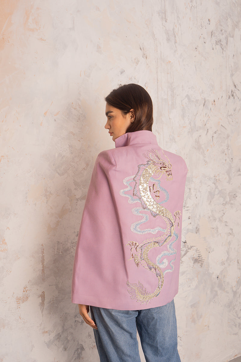 Nadya Shah Hydra Lilac Cape jacket displayed on a hanger, showcasing its soft fabric and elegant lilac color.