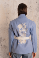 Nadya Shah NYLA Powder Blue Belted Jacket displayed on a hanger, showcasing its tailored fit and stylish design.
