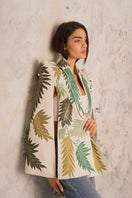 Nadya Shah Cara Leaf Cape jacket in lightweight fabric with a leafy pattern, displayed on a hanger against a neutral background.