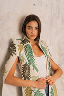 Nadya Shah Cara Leaf Cape jacket with leaf-patterned design in lightweight fabric, displayed on a hanger.