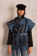 Nadya Shah Twist Denim Jacket with classic blue denim fabric, button-front, and fitted style, shown on a hanger.