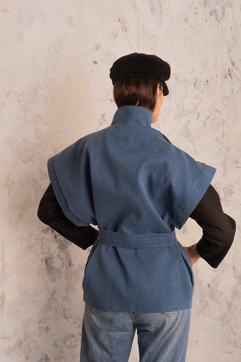 Nadya Shah Twist denim jacket, casual outerwear with a classic blue denim design and button-front closure, displayed on a hanger.