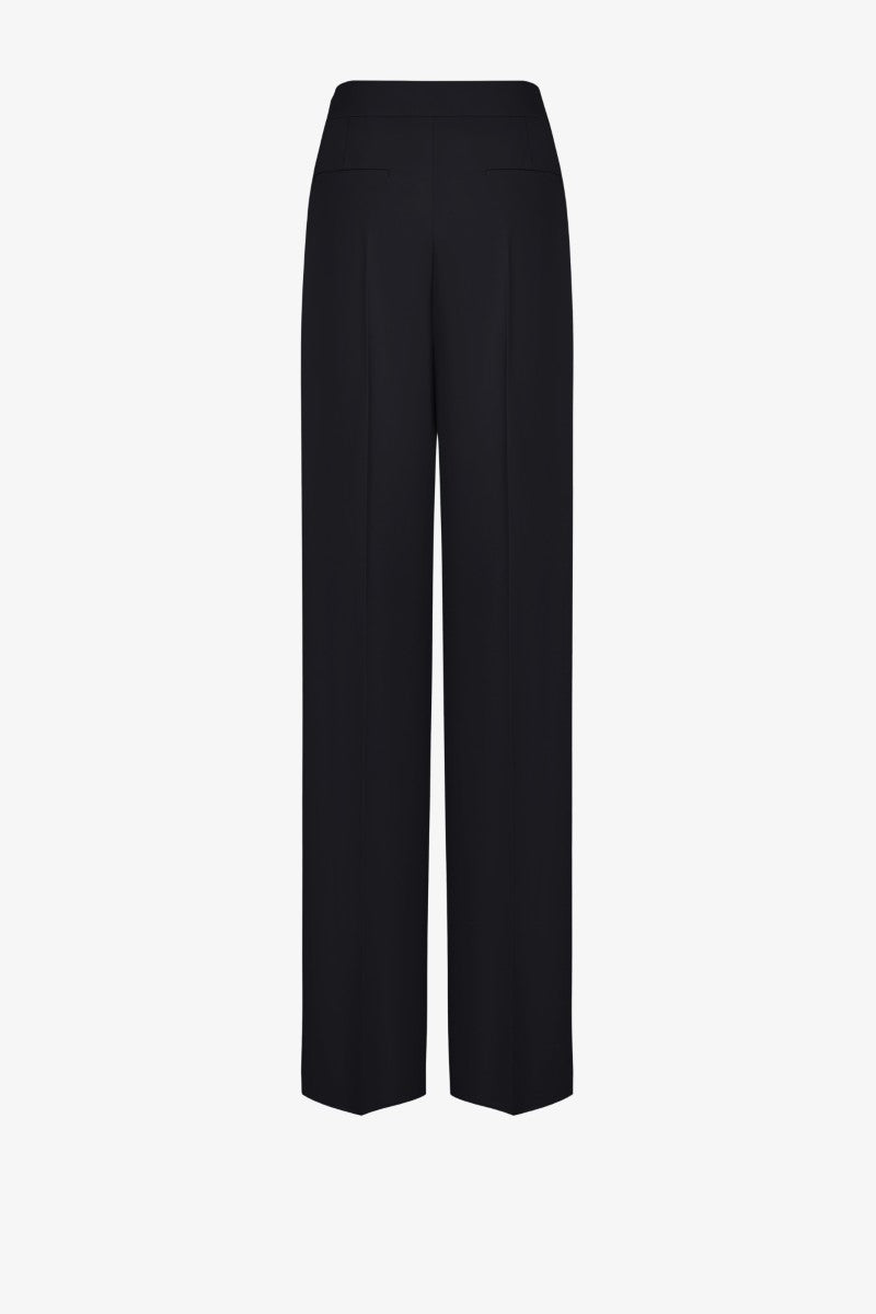 Black LEKIEU Kenya pants with a relaxed fit, shown hanging on a hanger against a plain background.