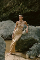 Maylé Vásquez DORADO Maxi Dress with flowing fabric and vibrant pattern, perfect for summer or casual occasions.