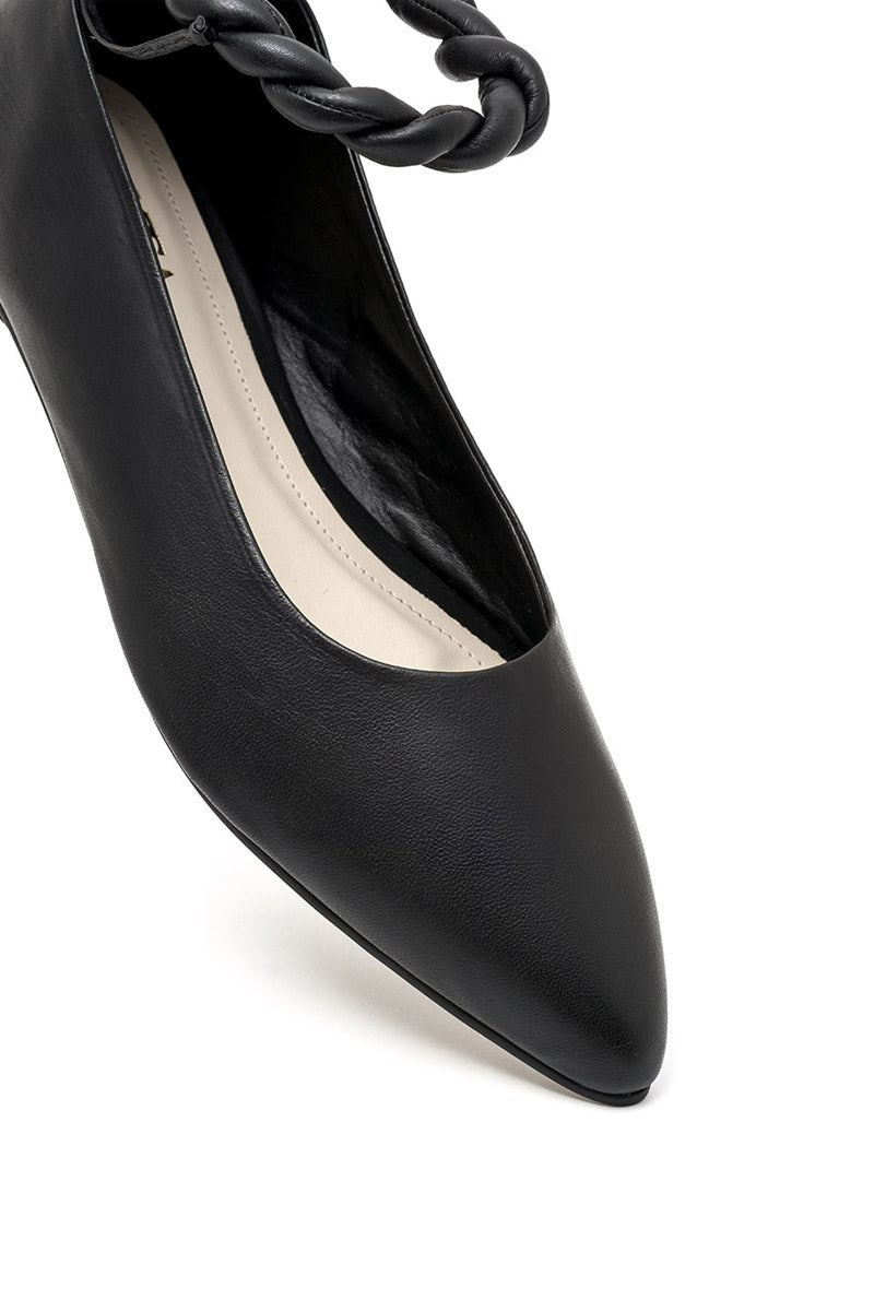 Black flats from ALTA ARIA collection with sleek design and comfortable fit, shown on a model wearing casual attire.