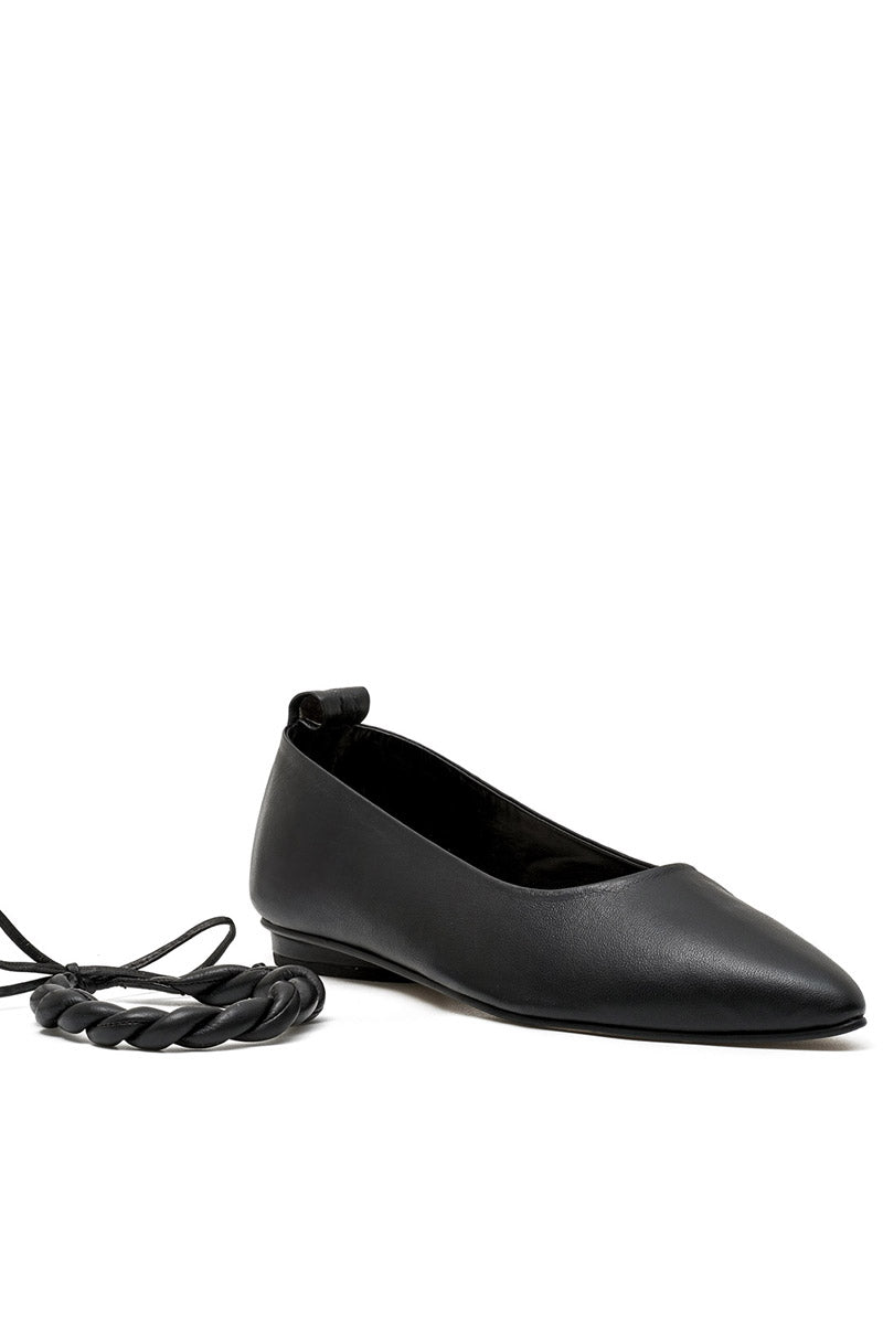Black flats from ALTA's ARIA collection, showcasing sleek, comfortable slip-on footwear with a smooth finish and minimal design.