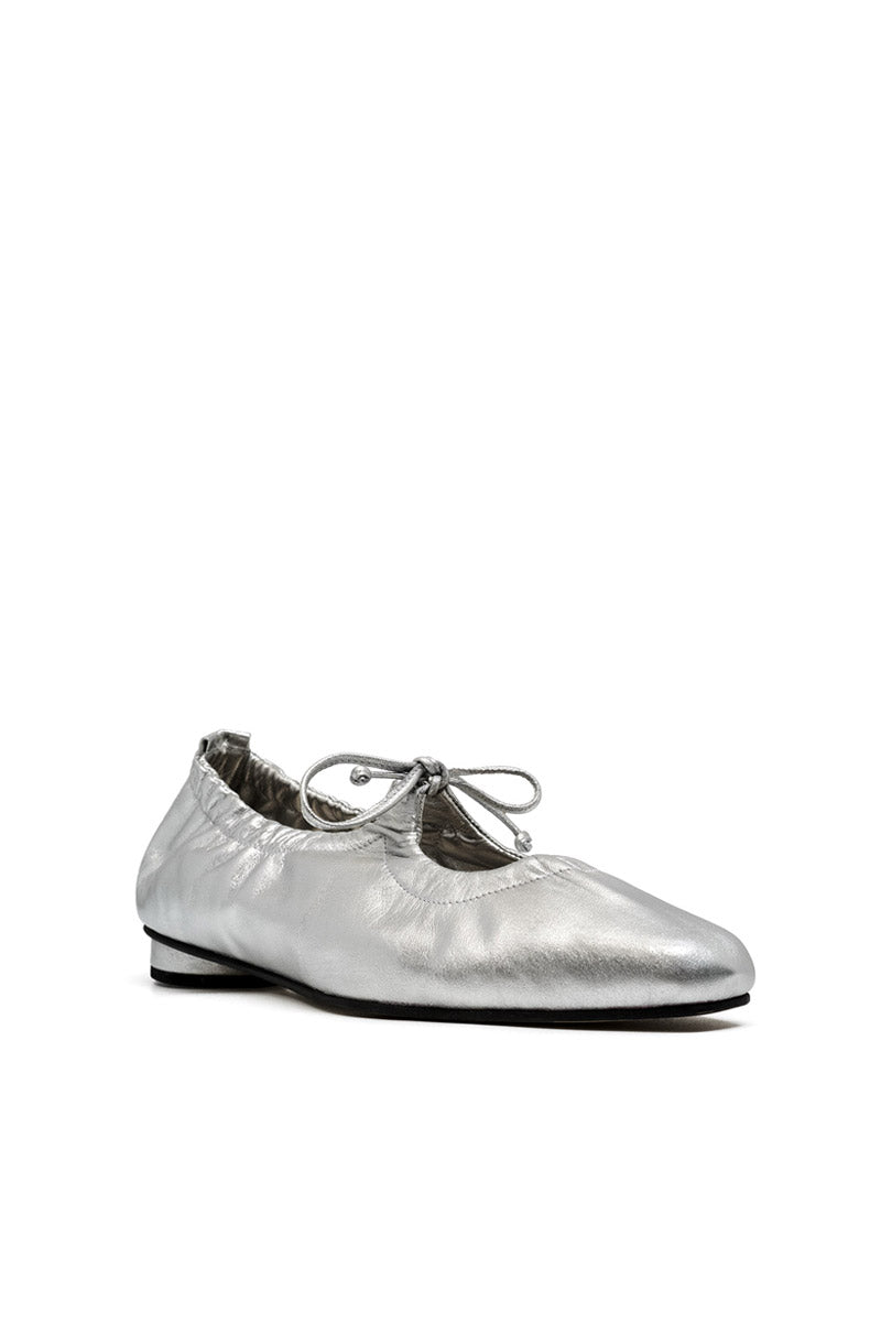 Alta Gemma silver flats with rounded toe and minimalist design, featuring a smooth silver finish and comfortable slip-on style.